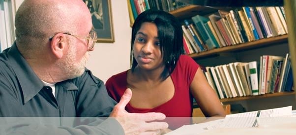 Student Talking to College Professor