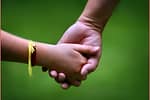 Mom and her young daughter holding hands