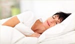 Woman Lying in Bed Sleeping