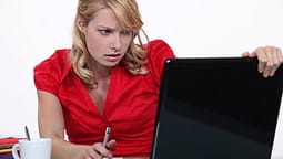 data security woman in red working on laptop