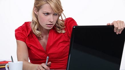data security woman in red working on laptop