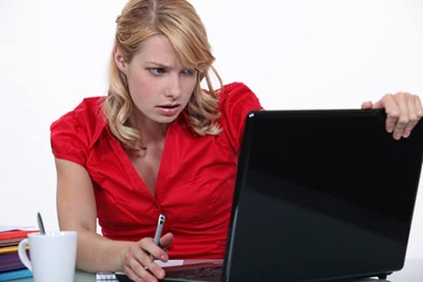 data security woman in red working on laptop
