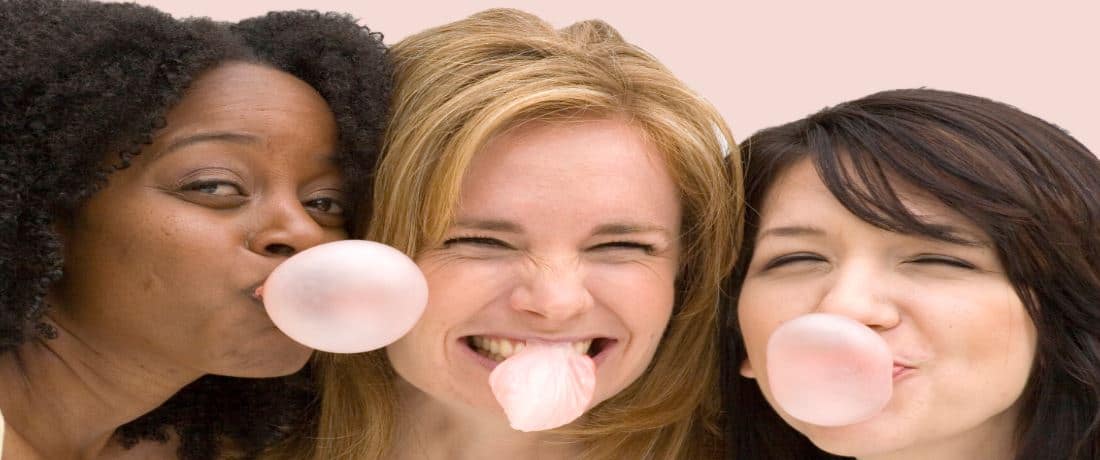 Ladies Having Fun Blowing Bubbles with Gum