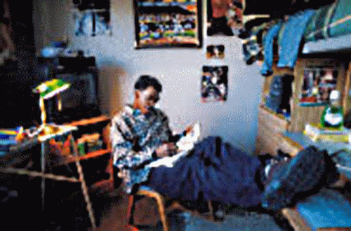 Image of Student Reading in Dorm Room