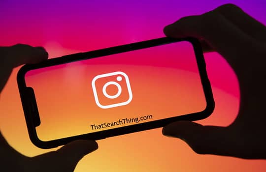 An instagram logo on the screen of a smartphone