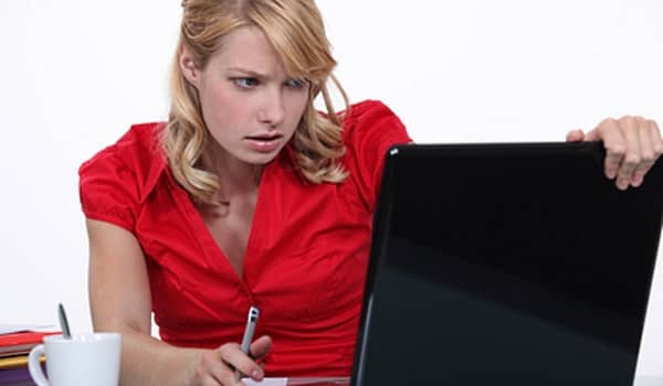 data security woman in red working on laptop