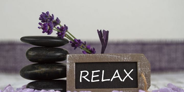 Spa Stones with the word "Relax" written on a small chalk board.
