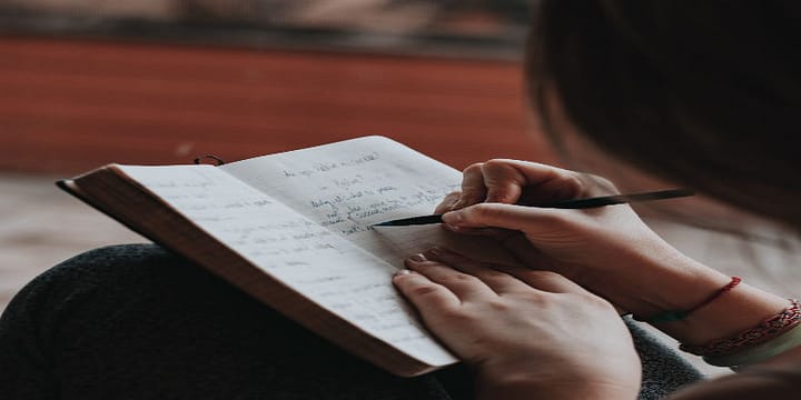 Image of Woman Writing in a Journal