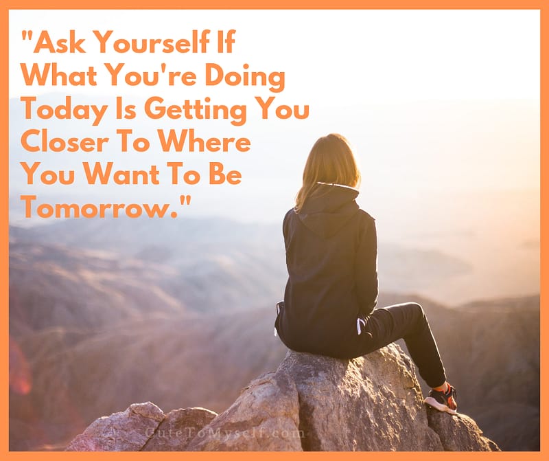 A Woman sitting on rocks on mountain